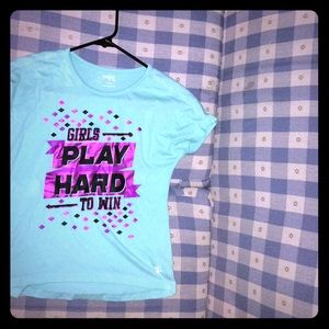A bluish shirt That say “girls play hard to win”